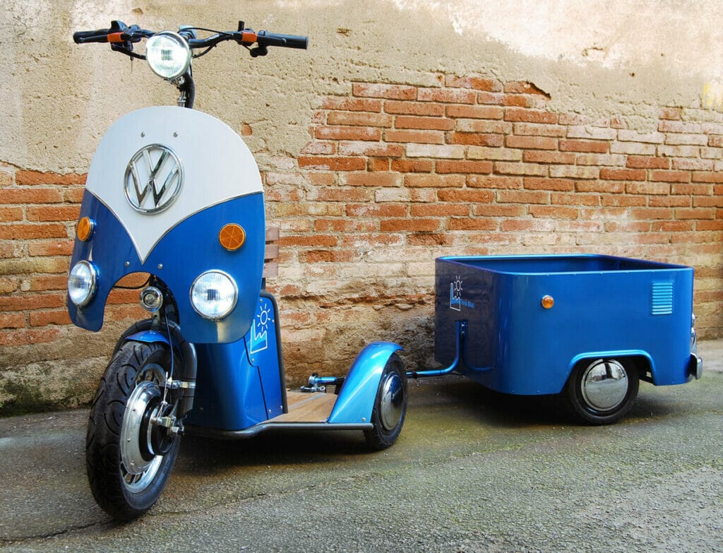 A blue motorcycle with a trailer attached to it.