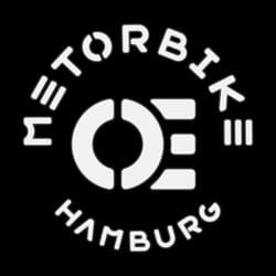 A circular logo features the words "Motorbike Hamburg" surrounding a central design element on a black background.