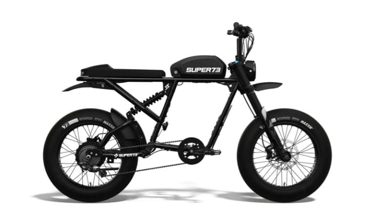 Side view of a black Super73 electric bike with thick tires, a minimalist frame, and a rectangular seat.