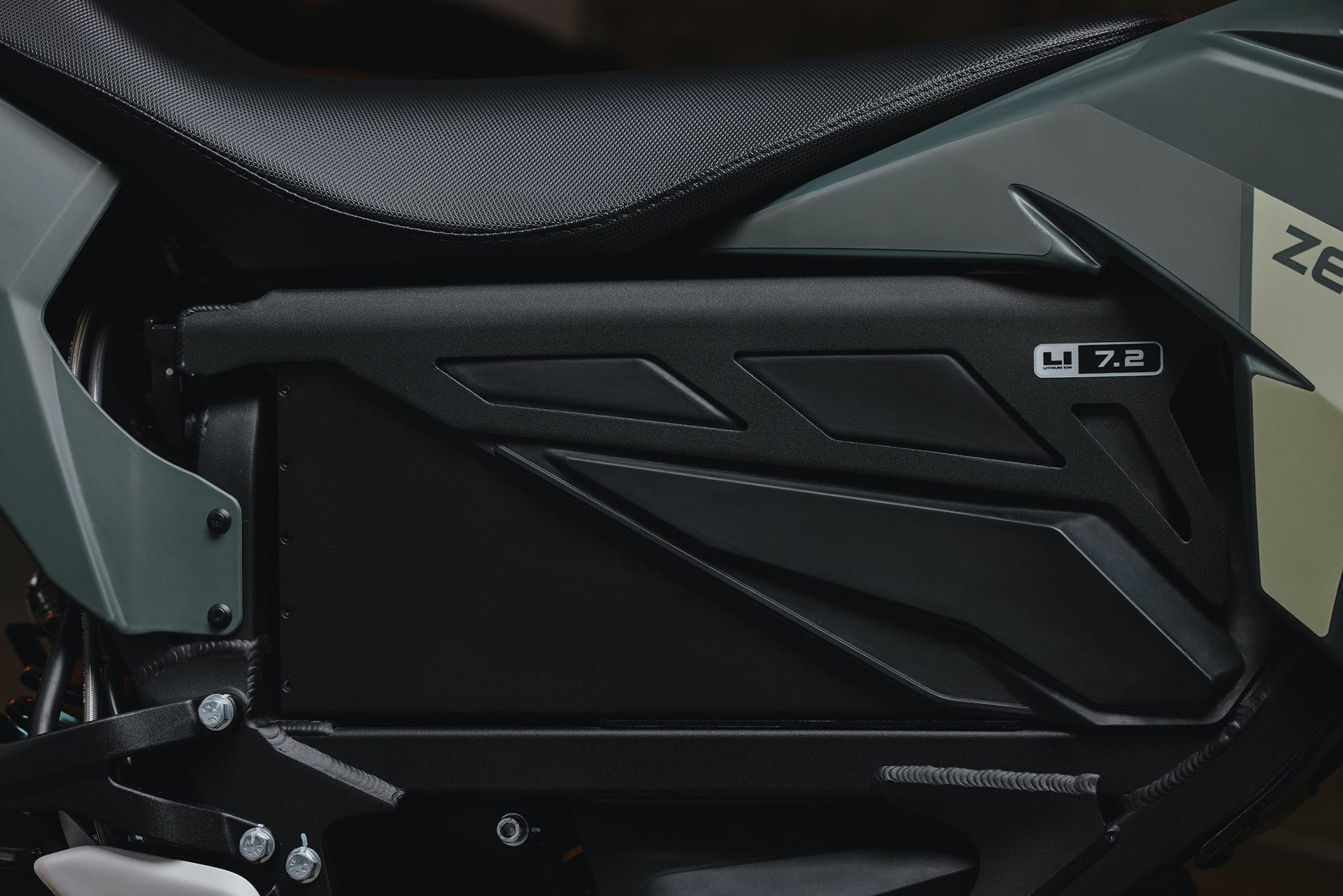 Close-up view of the side panel of a motorcycle, displaying a logo with the text "ZF 7.2" on a matte black and gray surface.