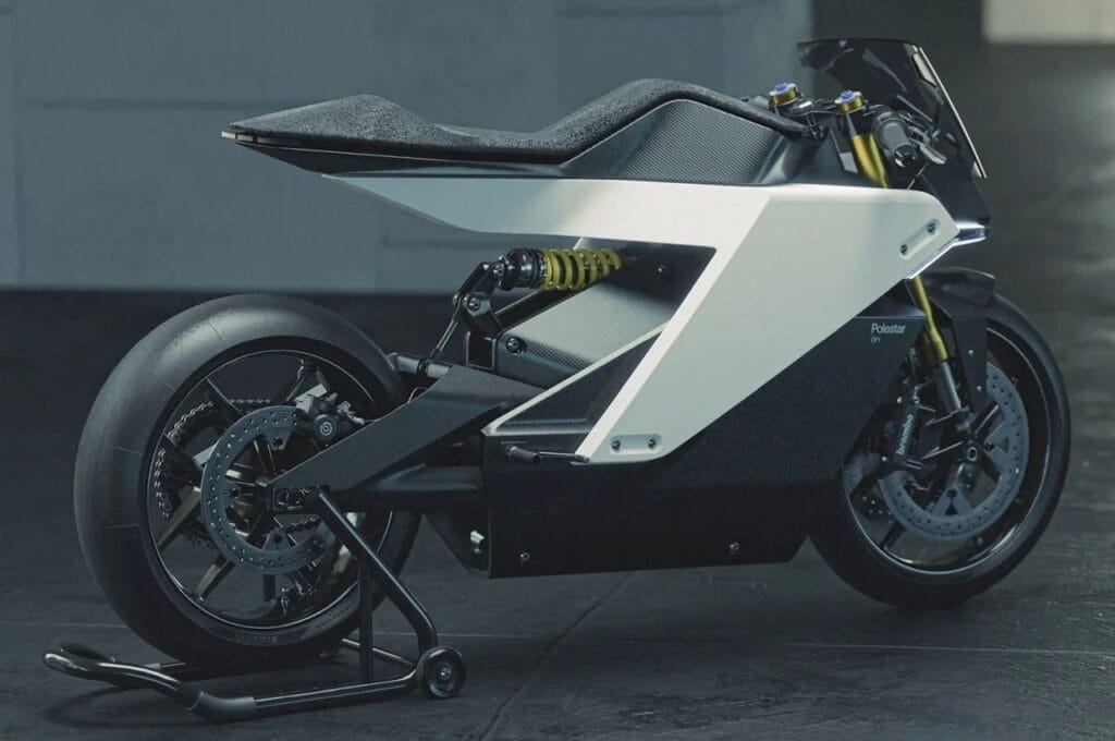 A white and black motorcycle is parked in a dark room.