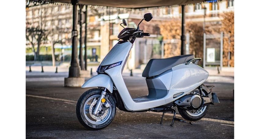 An electric scooter parked in a parking lot.