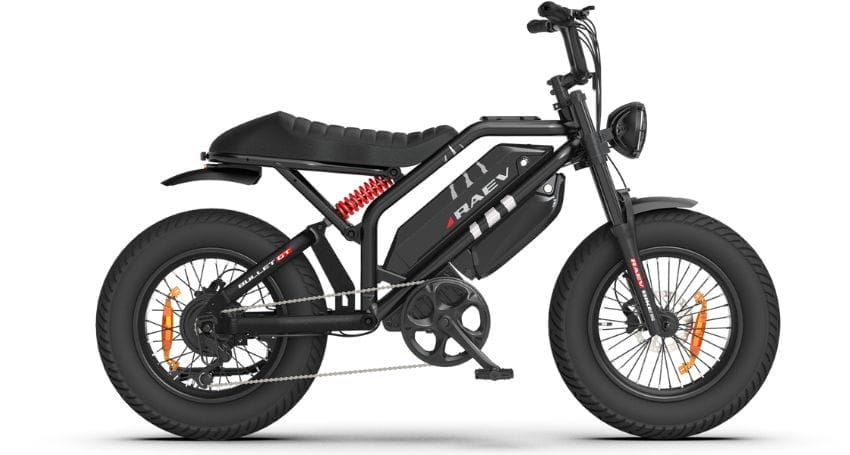 A black and gray electric bike with large tires, an elongated seat, and a central battery pack. The bike has a sleek, compact design and visible suspension components.