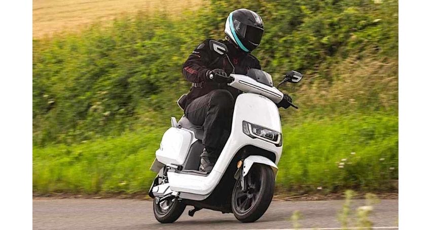 A person riding the best electric scooter down a country road, optimizing their commute.