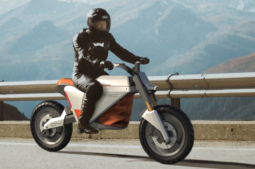 A man riding a motorcycle on a mountain road.