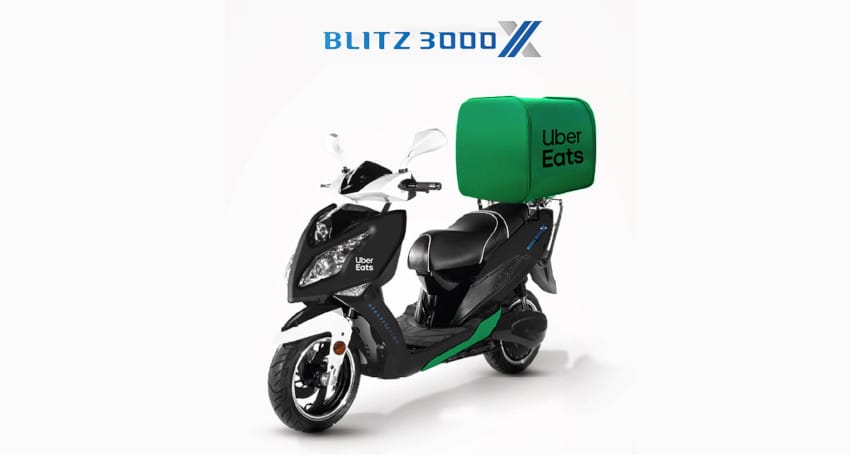 A Blitz 3000X electric scooter with Uber Eats branding, featuring a green delivery box on the back and a sleek black design.