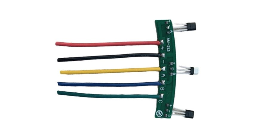 A small green circuit board with five colored wires (red, black, yellow, blue, green) and three components attached.