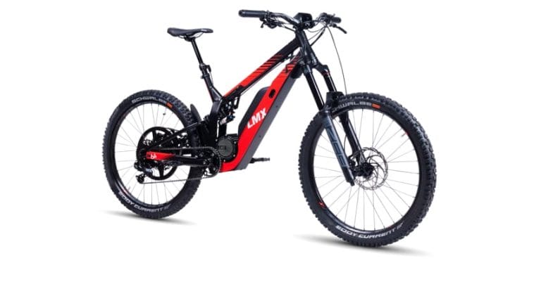 A red and black electric mountain bike with thick tires, front and rear suspension, and a central motor.