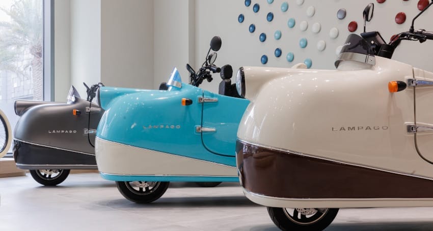 A blue and white scooter parked in a store.