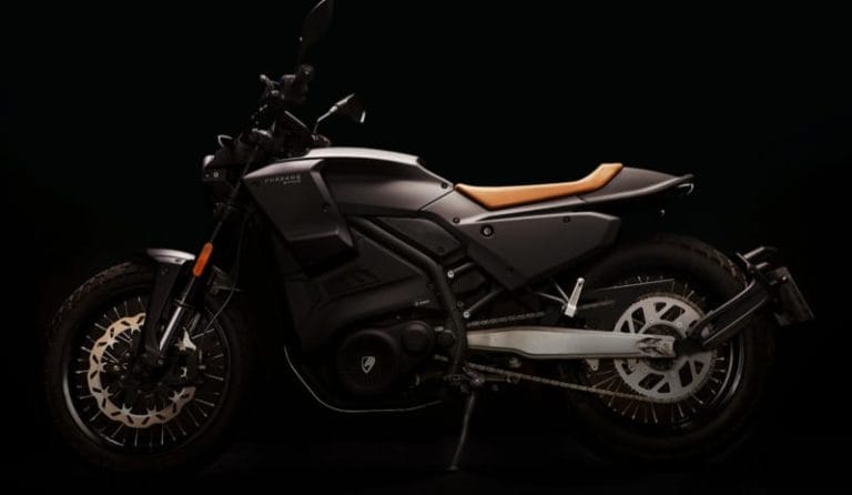 A sleek black motorcycle with a brown seat, shown in profile against a dark background.