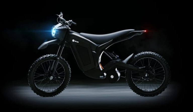 A sleek black electric dirt bike with knobby tires and a glowing blue headlight, displayed against a dark background.