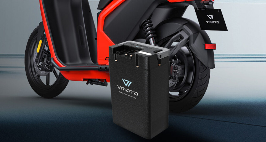 Electric scooter with a partially removed Superfast Charging Battery. The battery, labeled "Vmoto," stands beside the rear wheel of the red and black scooter.