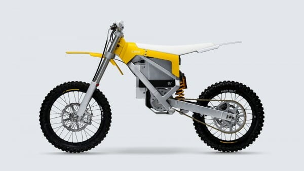 Side view of a yellow and white electric dirt bike with knobby tires, front and rear suspension, and minimalistic design.