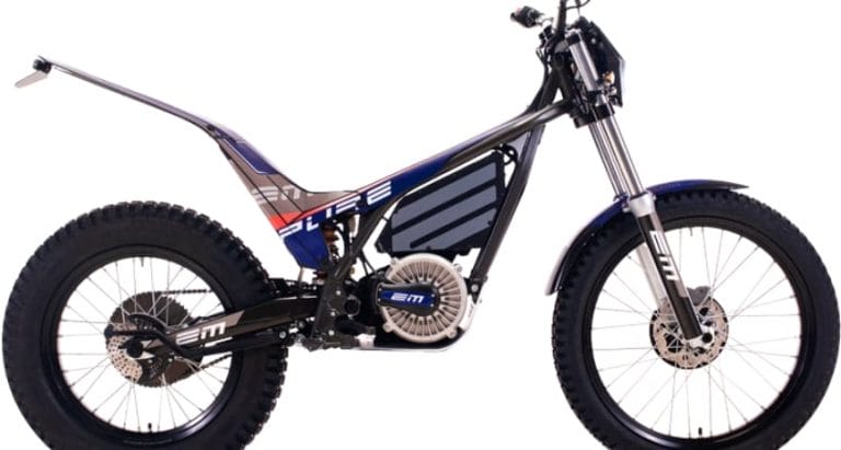 Side view of a modern electric dirt bike with a sleek design, featuring large knobby tires, minimalistic seat, and a compact electric motor.