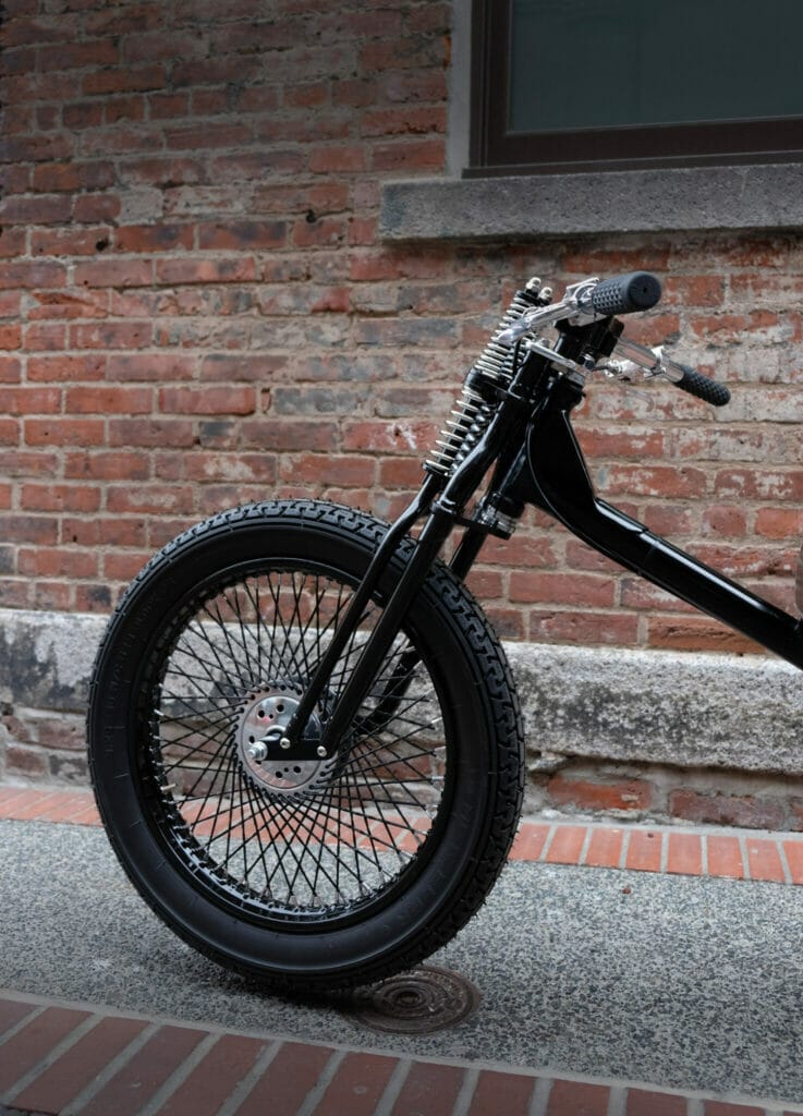 Black motorcycle, brick building.