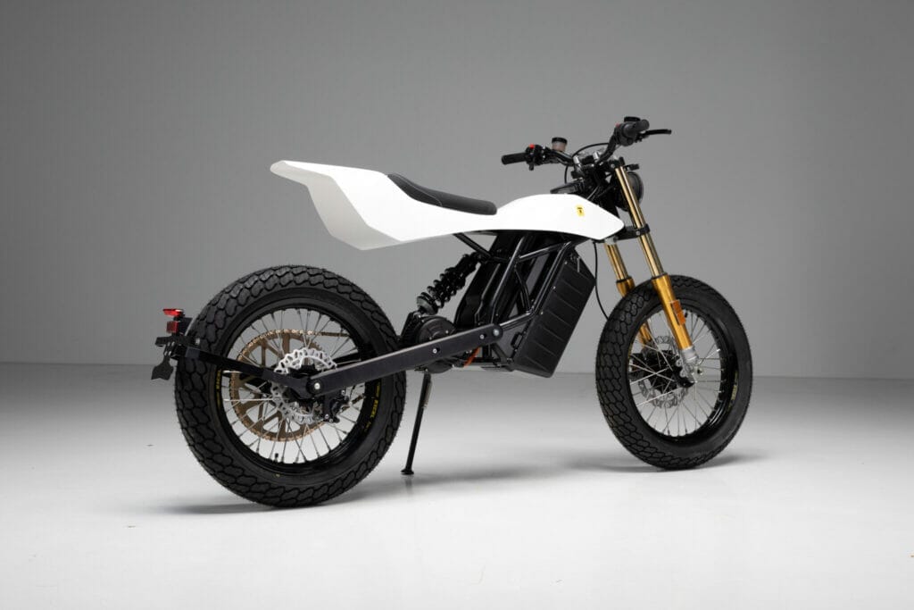 A white and black electric dirt bike on a white background, Trevor Motorcycles | Revolutionizing Flat Track Racing.