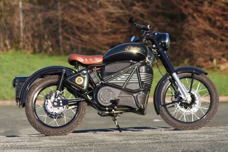 A black motorcycle, potentially Royal Enfield's, parked on the side of the road.