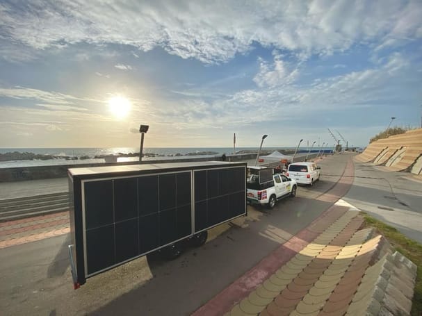 A truck with a solar panel on the side of it.