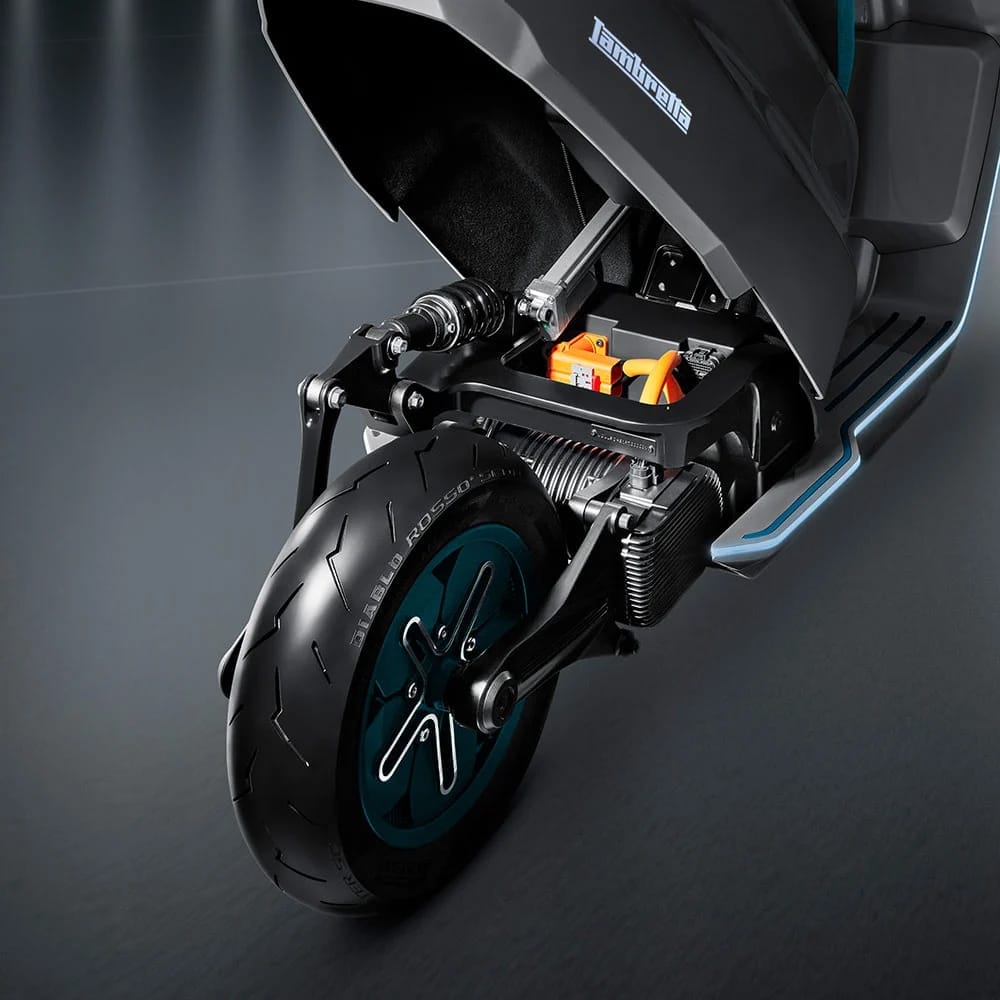 A black scooter with a blue front wheel.