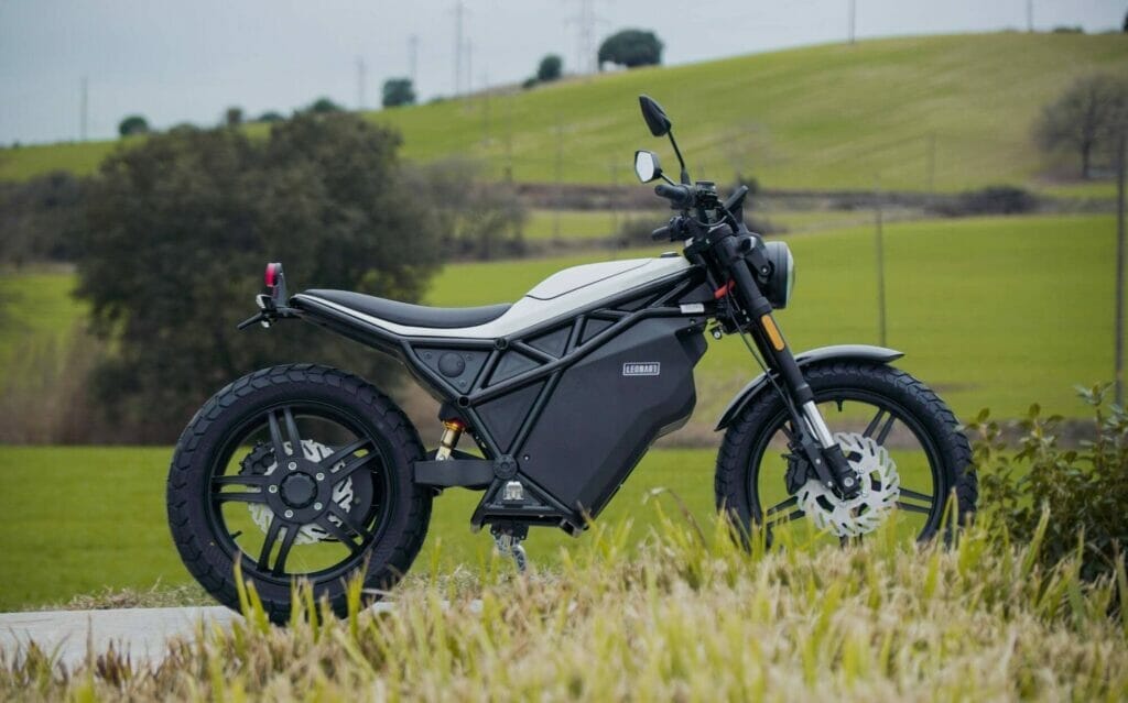 a motorcycle parked on top of a lush green field