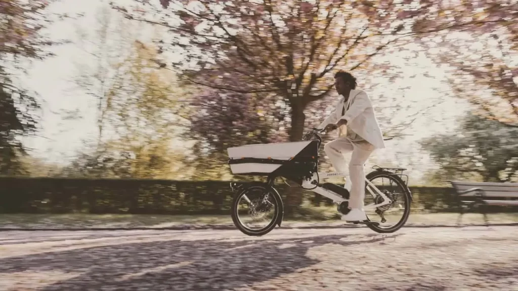 A woman riding a bicycle in a park.