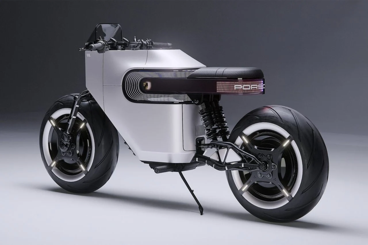 A sleek, futuristic silver motorcycle with a minimalist design and thick tires, viewed from a three-quarter rear angle in a studio setting.