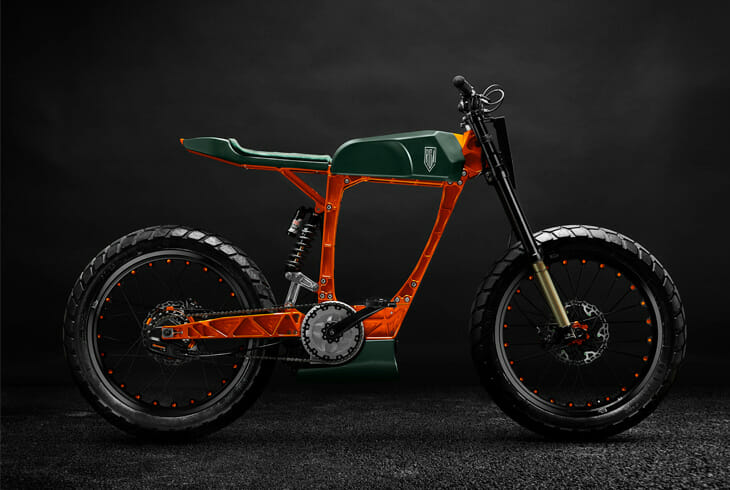 A modern electric bicycle with a green and orange frame is displayed against a dark background. The bike features thick tires and a minimalist design.