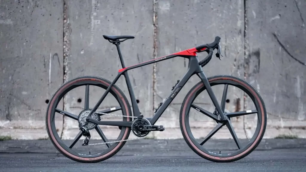 An auto bike is parked in front of a concrete wall.